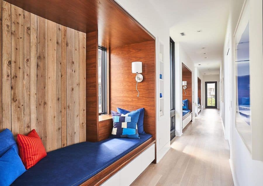 Wooden window seat, blue cushions, long hallway