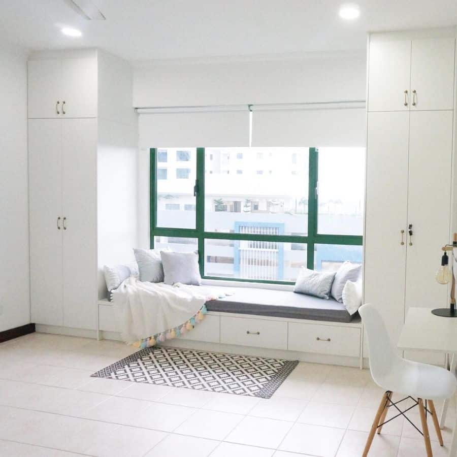 White cabinets, window seat, green treatment, gray cushion 
