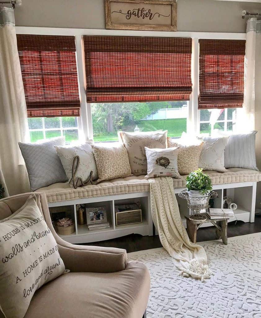 Country style window seat with red blinds and accent chair 