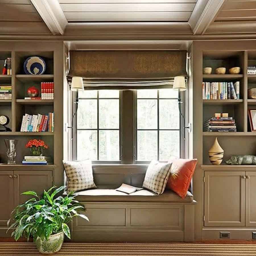 Reading corner, gray cushions, bookshelves, potted plant 