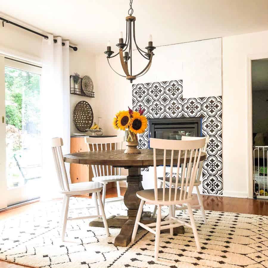 Farmhouse dining room with patterned tile fireplace 