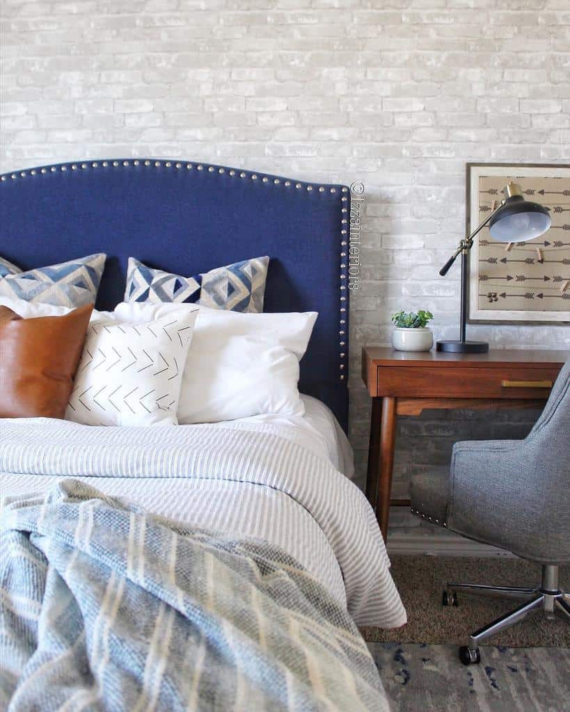 white brick wallpaper, blue bed, wooden desk