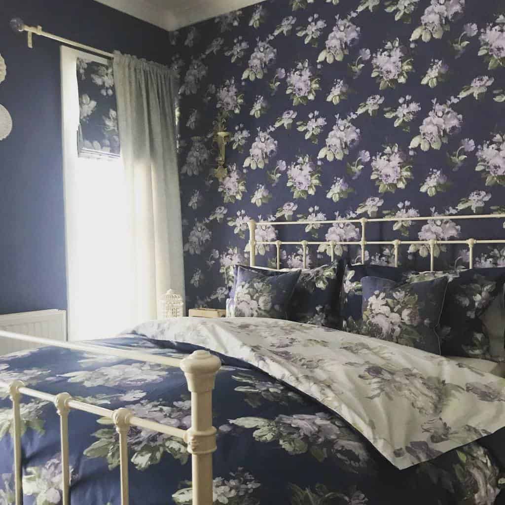 Floral bedroom wallpaper, white bed