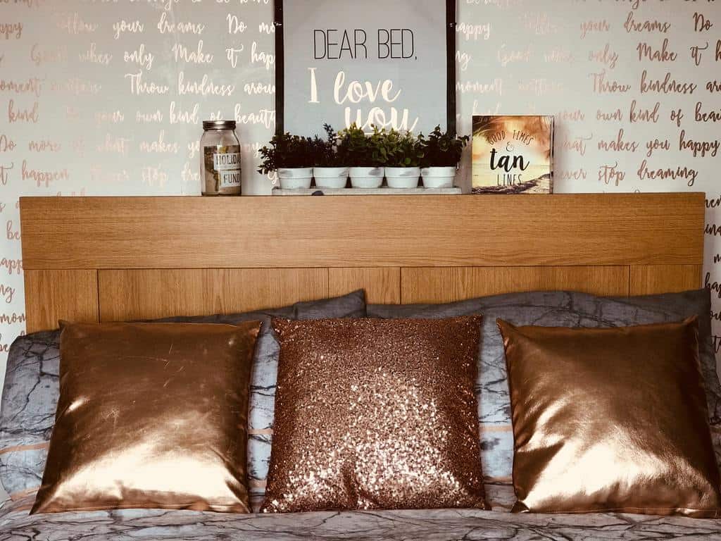 Wall lettering and bed cushions in gold metallic 