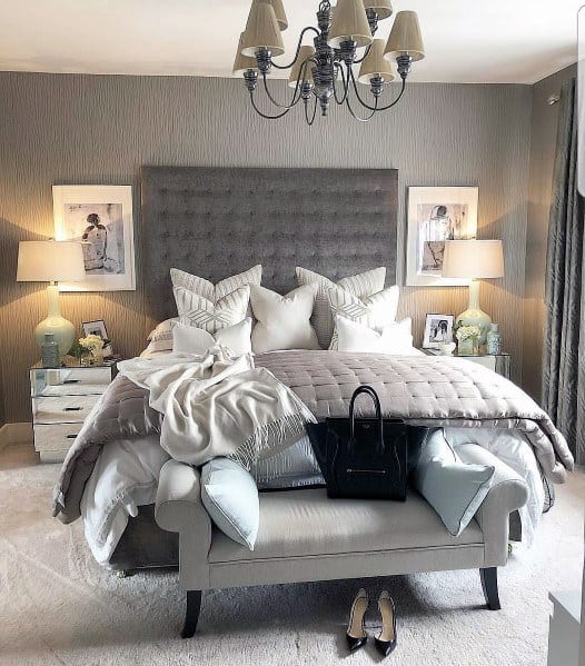 Luxury bedroom with framed faux silver next to tables 