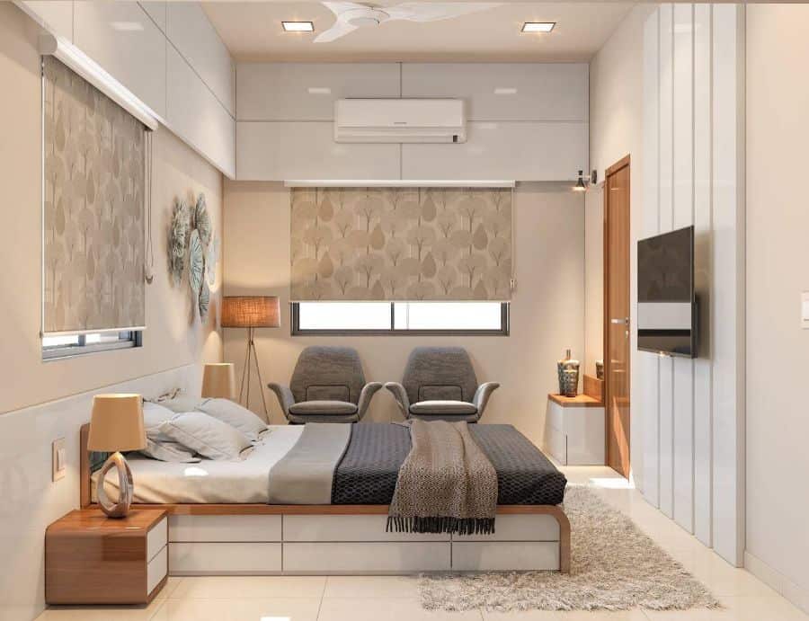 Modern small bedroom with platform bed and gray accent chairs 