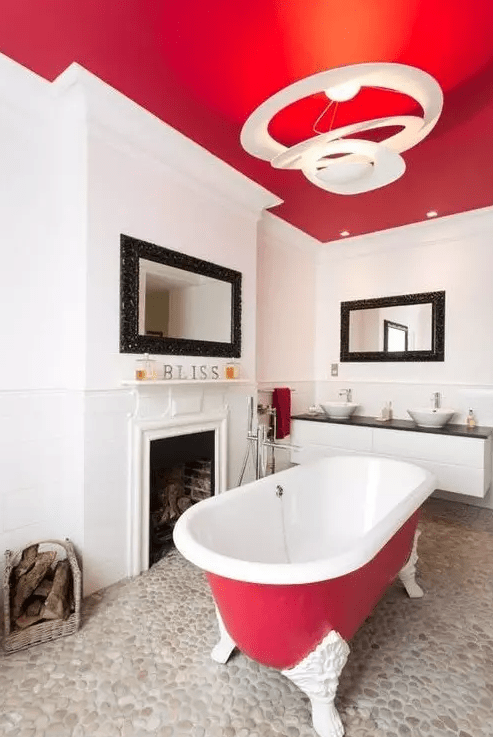 A bright red ceiling and echoey bathtub make the space bold while adding personality