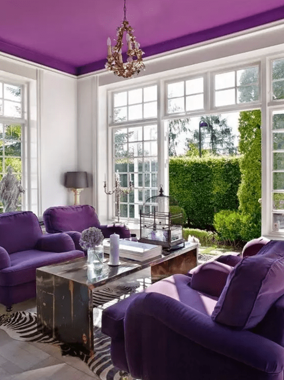 an elegant living room with a bold purple ceiling, purple seating, a stained table and animal-print rugs