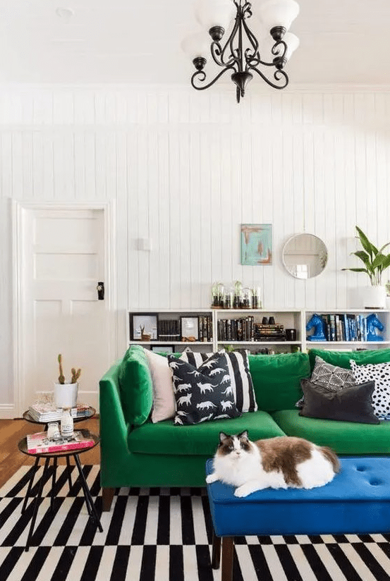 an emerald green Stockholm sofa and a bold blue upholstered bench to spice up a monochrome interior