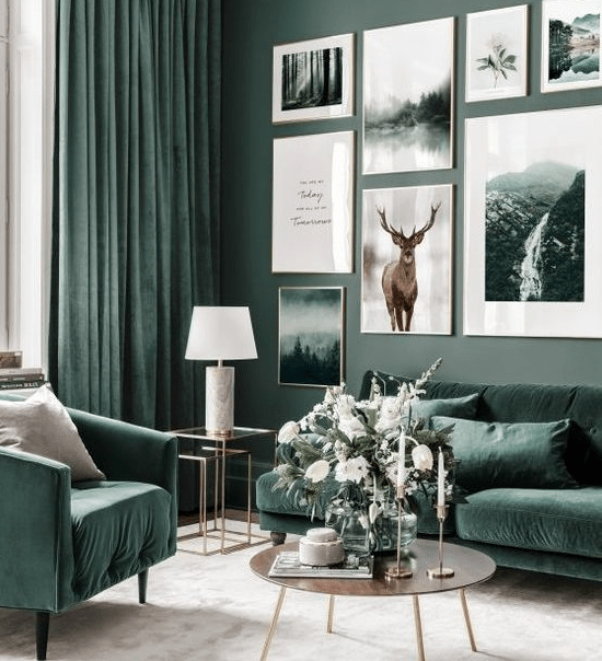 a nature-inspired living room with gray-green walls, hunter green furniture and matching curtains, and a large gallery wall