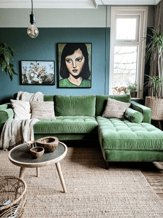 a whimsical living room with a blue accent wall, a green sitting area, a jute rug, a coffee table, some art and potted plants