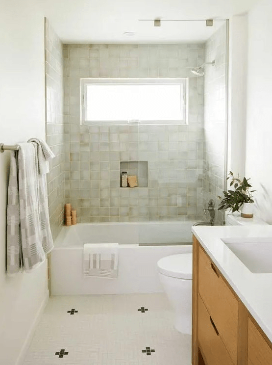a modern bathroom with neutral walls and green terrazzo tiles, a stained vanity, a neutral tile floor and white appliances