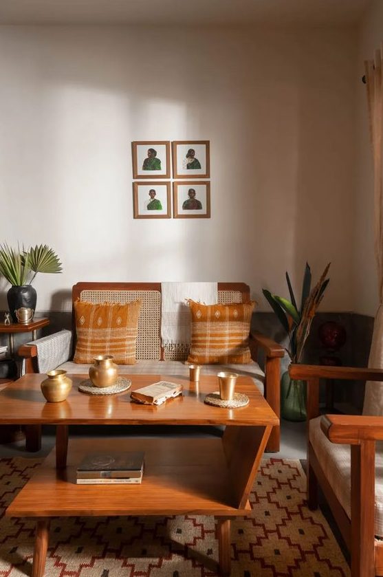A mid-century modern living room in earth tones, with a wicker sofa and chair, a tiered coffee table and some plants