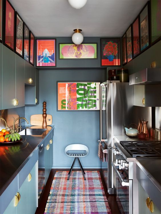 an atmospheric green kitchen with matching cabinets, a double-sided gallery wall and a striking, bright carpet