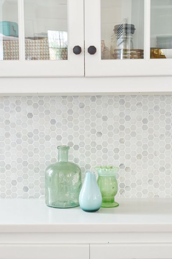 Marble hex penny tiles with white grout look timeless and add the right amount of interest to a neutral kitchen