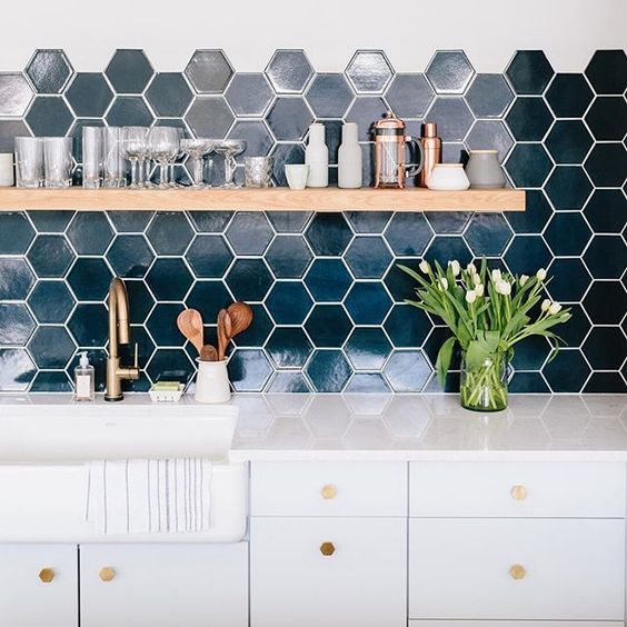 Chic dark green hexagon tiles with white grout make a bold statement in a neutral room