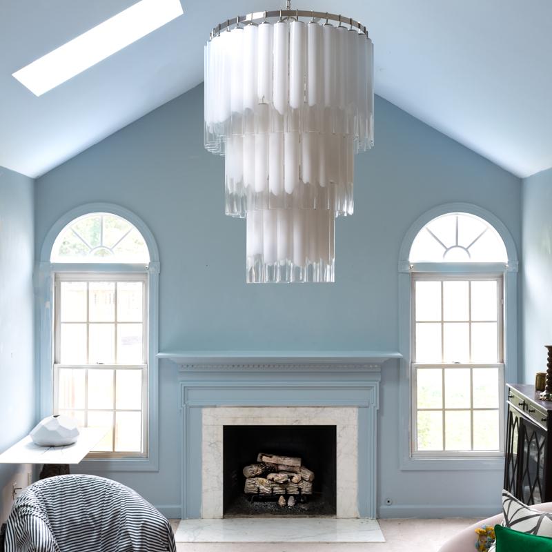 Opt for a statement chandelier to inspire elegance in your blue living room
