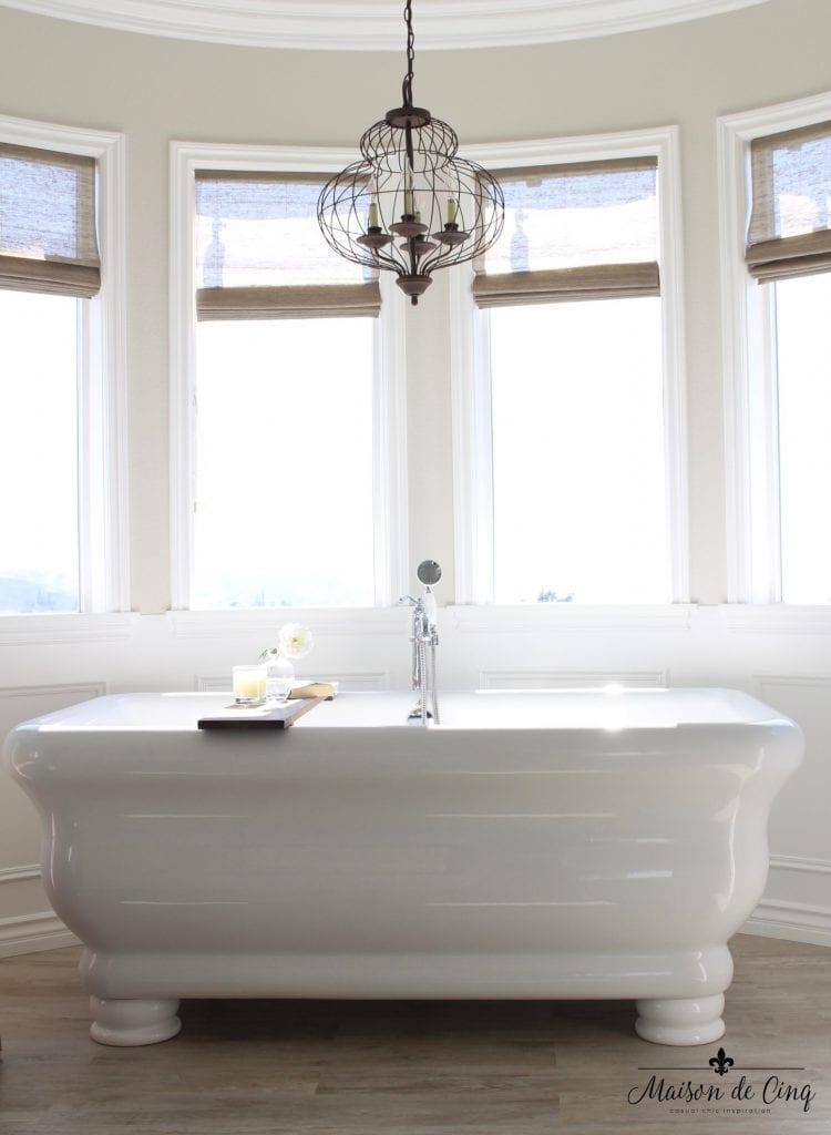 Choose a farmhouse-inspired freestanding tub for a chic focal point in your Farmhouse Bathroom