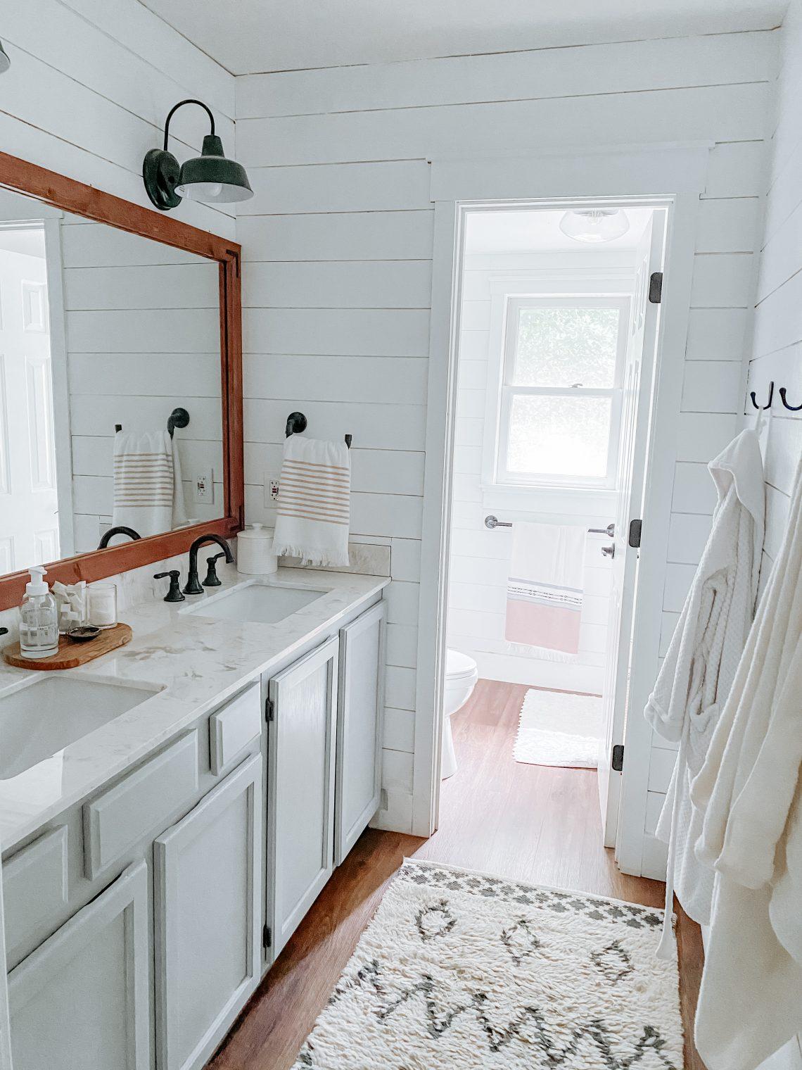 Embrace white shiplap walls for a bright and airy farmhouse bathroom ambience