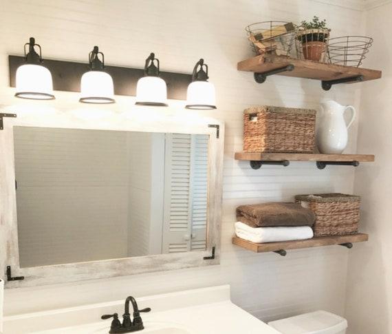 Open shelving provides practical storage and displays charming decor in your farmhouse bathroom