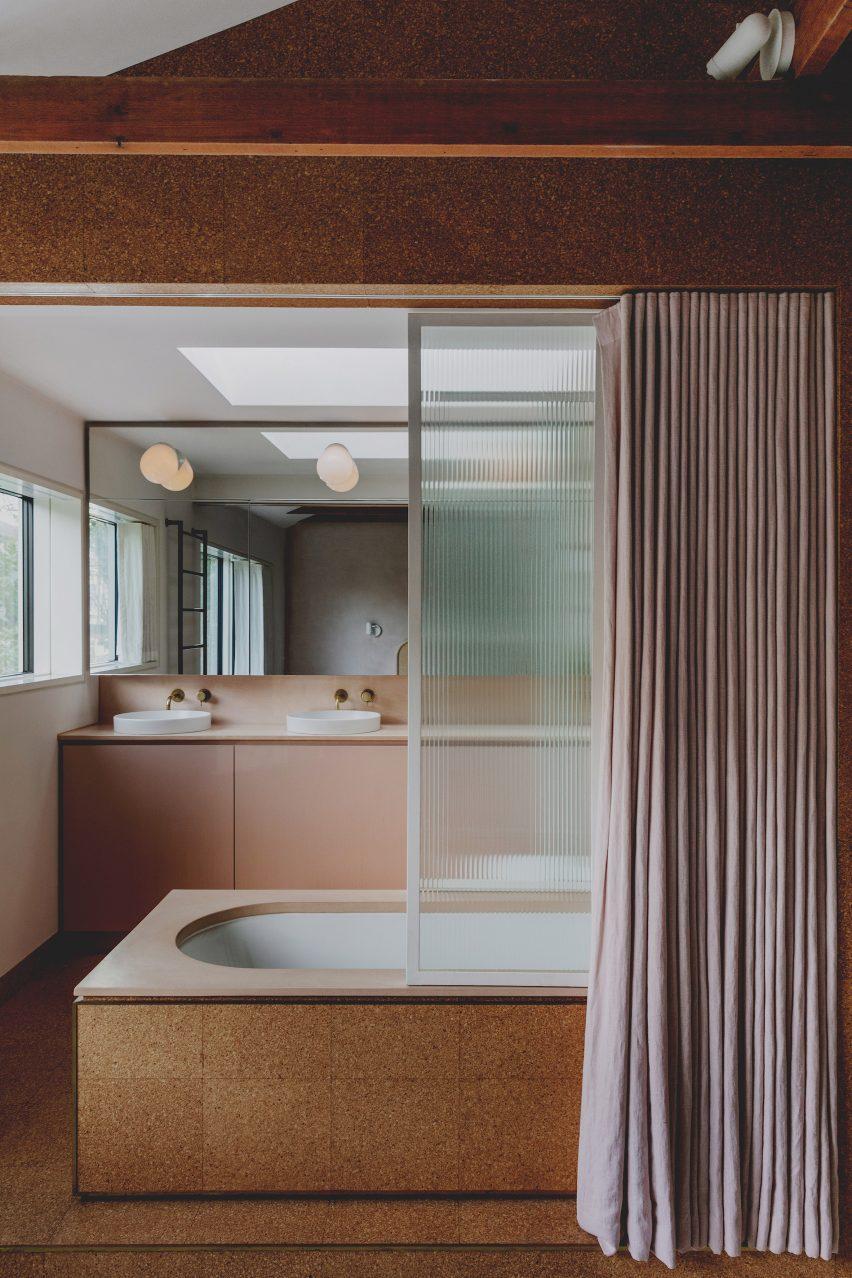 A wood-clad bathtub becomes a stunning centerpiece in a wooden bathroom retreat