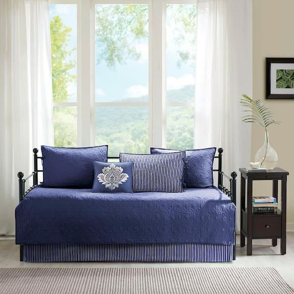 Layer blue bedding over a chic daybed in the living room