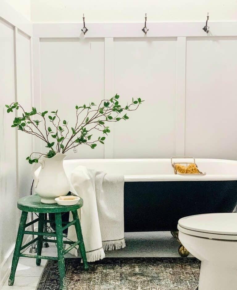 A‌ wooden stool ⁣for both seating and rustic decor‌ in the‌ bathroom