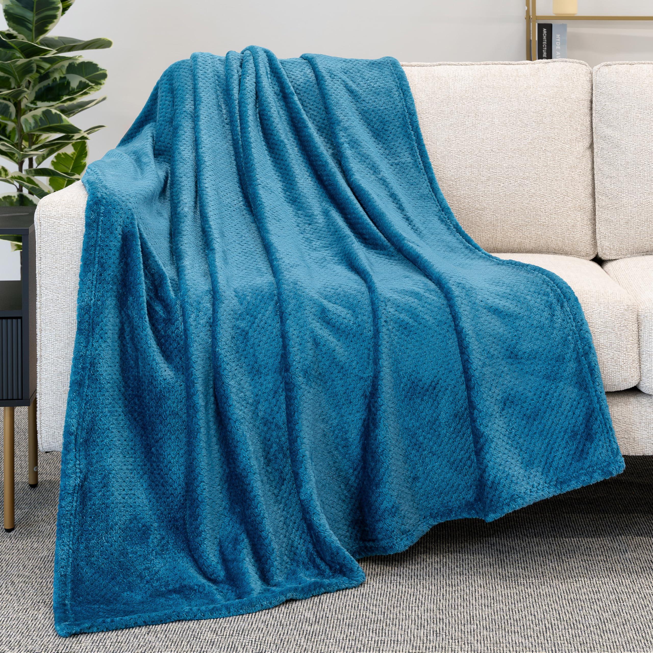 Incorporate textured throws for warmth in a blue living room