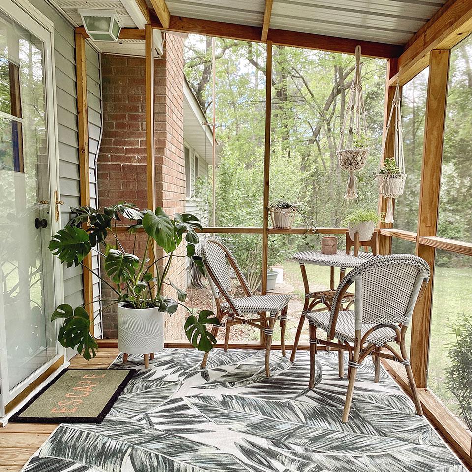 Use outdoor rugs to define spaces in your screened porch oasis