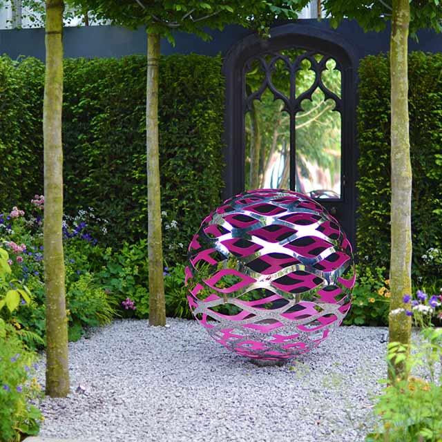 Hang a small outdoor art piece to personalize your small backyard