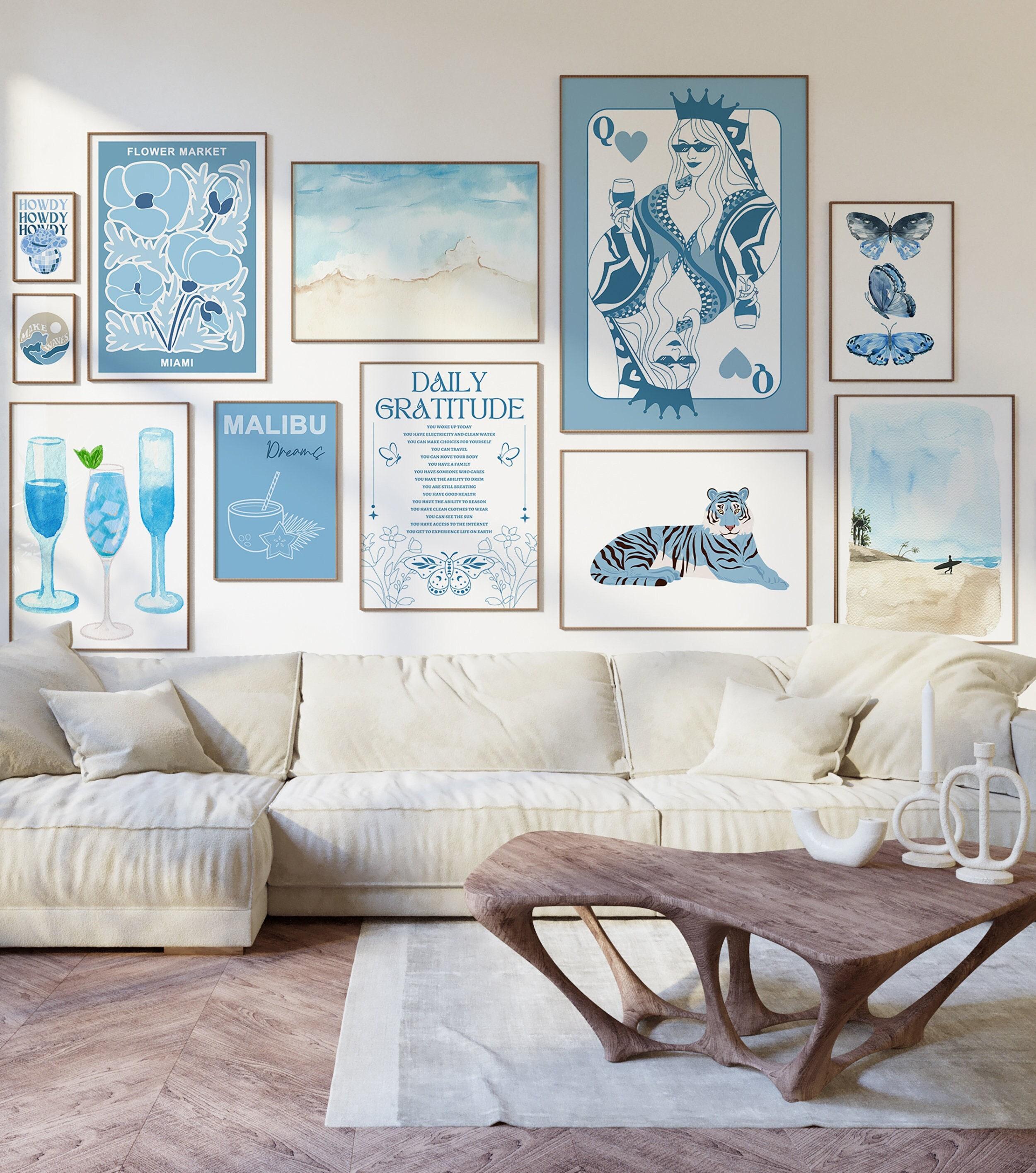 Create a gallery wall featuring blue-themed artwork and photographs