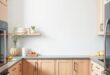 Chic Harmony: Light Gray Walls and Oak Cabinets Transform Your Kitchen Space